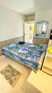 a bedroom with a bed with a mirror and a table at Casa Ayla Montecastillo A8 in Caleta De Fuste