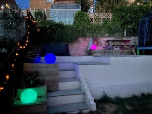 a set of stairs with green and blue balloons at Private en-suite garden room in Countess Wear