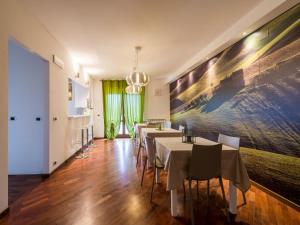 un comedor con mesas y una gran pintura en la pared en Alla scoperta delle Marche, en Camerino