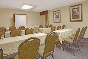 a conference room with tables and chairs and a whiteboard at Wyndham Garden Charlotte Airport Southeast in Charlotte