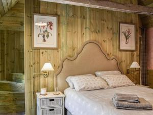 a bedroom with a bed and a wooden wall at The Potting Shed in Huntingdon