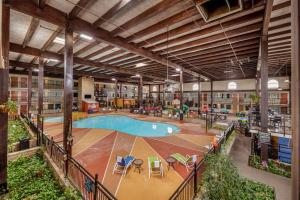 a large building with a pool in the middle at Pearl on the Concho SureStay Collection by Best Western in San Angelo