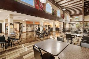 a dining room with tables and chairs in a building at Pearl on the Concho SureStay Collection by Best Western in San Angelo