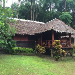 a wooden house with a thatched roof at Paradise Lost Bungalows in Koh Kradan