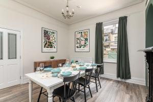 a dining room with a white table and chairs at Stunning Skipton House by Yorksha Property in Skipton