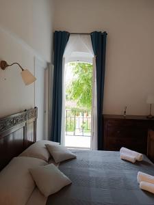 a bedroom with a bed and an open window at b & b ultimo miglio in Treviso