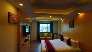 Een bed of bedden in een kamer bij Hotel Grand View