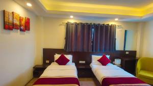 Ένα ή περισσότερα κρεβάτια σε δωμάτιο στο Hotel Grand View