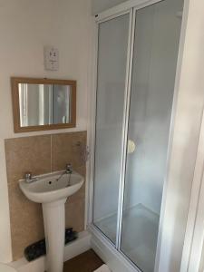 a bathroom with a shower and a sink at White Heather Guest House in Mablethorpe