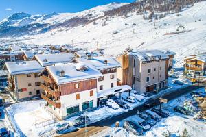 a town in the snow with snow covered buildings at Chalet Colombo MyholidayLivigno in Livigno