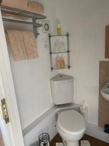 a bathroom with a white toilet and a sink at White Heather Guest House in Mablethorpe