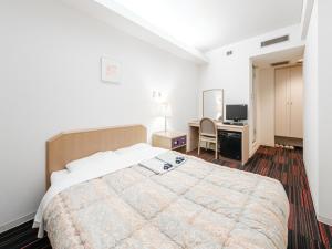 Кровать или кровати в номере Hotel Tetora Spirit Sapporo