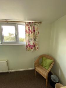 a small room with a chair and a window at White Heather Guest House in Mablethorpe
