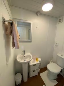 a bathroom with a sink and a toilet and a mirror at White Heather Guest House in Mablethorpe +28 photos