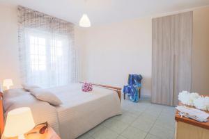 a bedroom with a large bed and a window at Green Marine B09 Silvi Vacanza in Silvi Marina