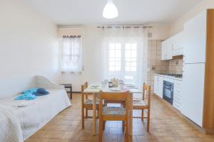 a kitchen and dining room with a table and chairs at Green Marine B09 Silvi Vacanza in Silvi Marina