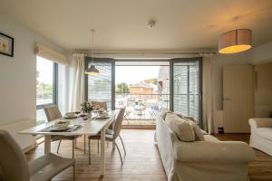 a living room with a table and a couch at 2 King Georges - Aldeburgh Coastal Cottages in Aldeburgh
