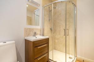 a bathroom with a shower and a sink at 2 King Georges - Aldeburgh Coastal Cottages in Aldeburgh
