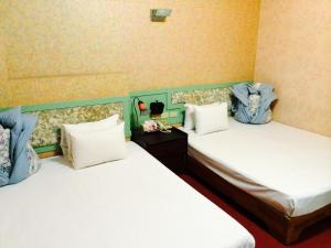 Letto o letti in una camera di Kai Cheng Inn 旅館134