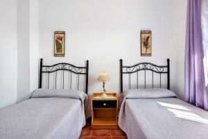 two beds sitting next to each other in a bedroom at Villa Perez Zara Paco in Campano +17 photos