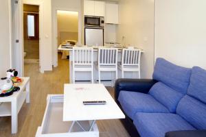 a living room with a couch and a table at vallespin 43 parking, wifi in Ávila