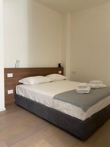 a bedroom with a bed with two towels on it at Torino 64 - Duomo City Center Luxury Apt Perfect x2! Self Check-In in Milan