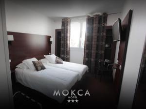 Voodi või voodid majutusasutuse Le Mokca toas