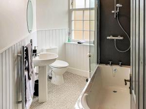 a bathroom with a sink and a toilet and a shower at The Legion in Saint Margarets Hope