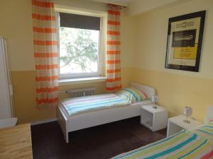 Ein Bett oder Betten in einem Zimmer der Unterkunft Gästehaus Grupello