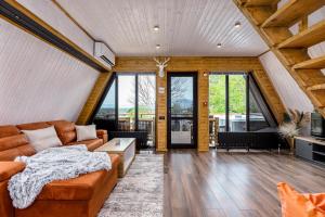 a living room with a couch and a table at Modern Wood Cottages in Mtskheta