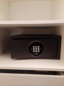 a black microwave oven sitting on top of a shelf at Hanza Tower Sunny Apartment in Szczecin