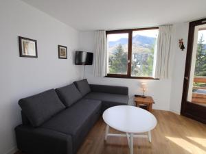 a living room with a couch and a table at Appartement Avoriaz, 2 pièces, 4 personnes - FR-1-633-53 in Morzine