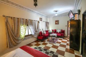 a room with a bed and a couch and a table at DAR EL AAMOURI in Fez