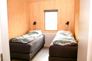 Uma cama ou camas num quarto em Hulduland 1, Hálönd, Akureyri
