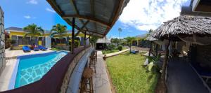 a resort with a swimming pool and a building at Casa da Luna Watamu Kenya in Watamu