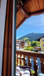 a balcony with chairs and a view of the mountains at Appartement Wurzrainer in Westendorf