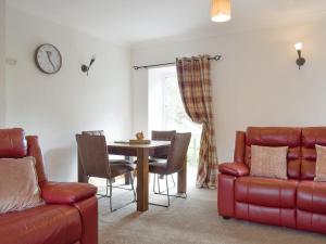 a living room with a table and chairs at The Barn in Fintry