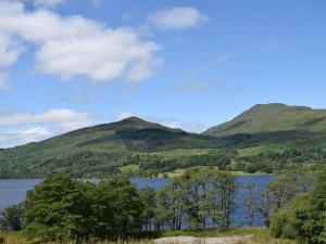 a view of a lake with mountains in the background at The Barn in Fintry