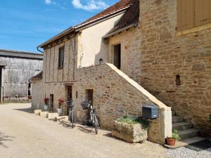 a bicycle parked outside of a brick building at Au Vieux Séchoir in Prudhomat