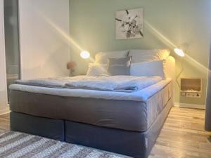 a large bed in a room with lights on it at Living at Saarpartments -Adults Only- 2 Bedrooms, Netflix - Business & Holiday Apartments for Long- and Short term Stay, 3 min to Train Station and Europa Galerie in Saarbrücken