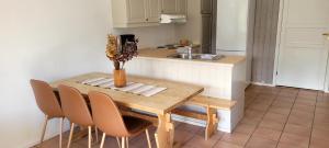 a small kitchen with a wooden table and chairs at Øen Turistsenter Apartments in Geilo +12 photos