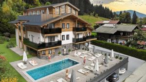 an aerial view of a house with a swimming pool at Aparthotel Fuxbau in Flachau