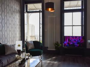 a living room with a couch and a window at Harbour Retreat in Ramsgate