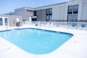 a large swimming pool in front of a building at Holiday Inn Express Marshfield - Springfield Area, an IHG Hotel in Marshfield