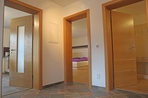 two doors in a room with a bedroom at Zeilner Dachstein Apartment in Gosau