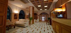 a lobby with two chairs and a television in a building at Hotel Regio 2 in Cádiz