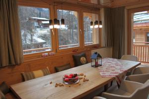 a dining room table with a bowl of fruit on it at Chalet Binna in Zermatt