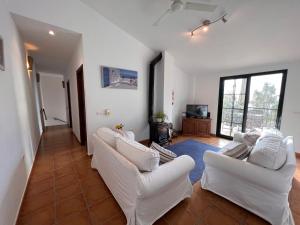 a living room with white couches and a television at Padre Aviles in Olías