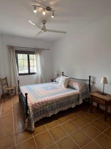 a bedroom with a bed and a ceiling fan at Padre Aviles in Olías