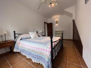 a bedroom with a bed in a room with a staircase at Padre Aviles in Olías